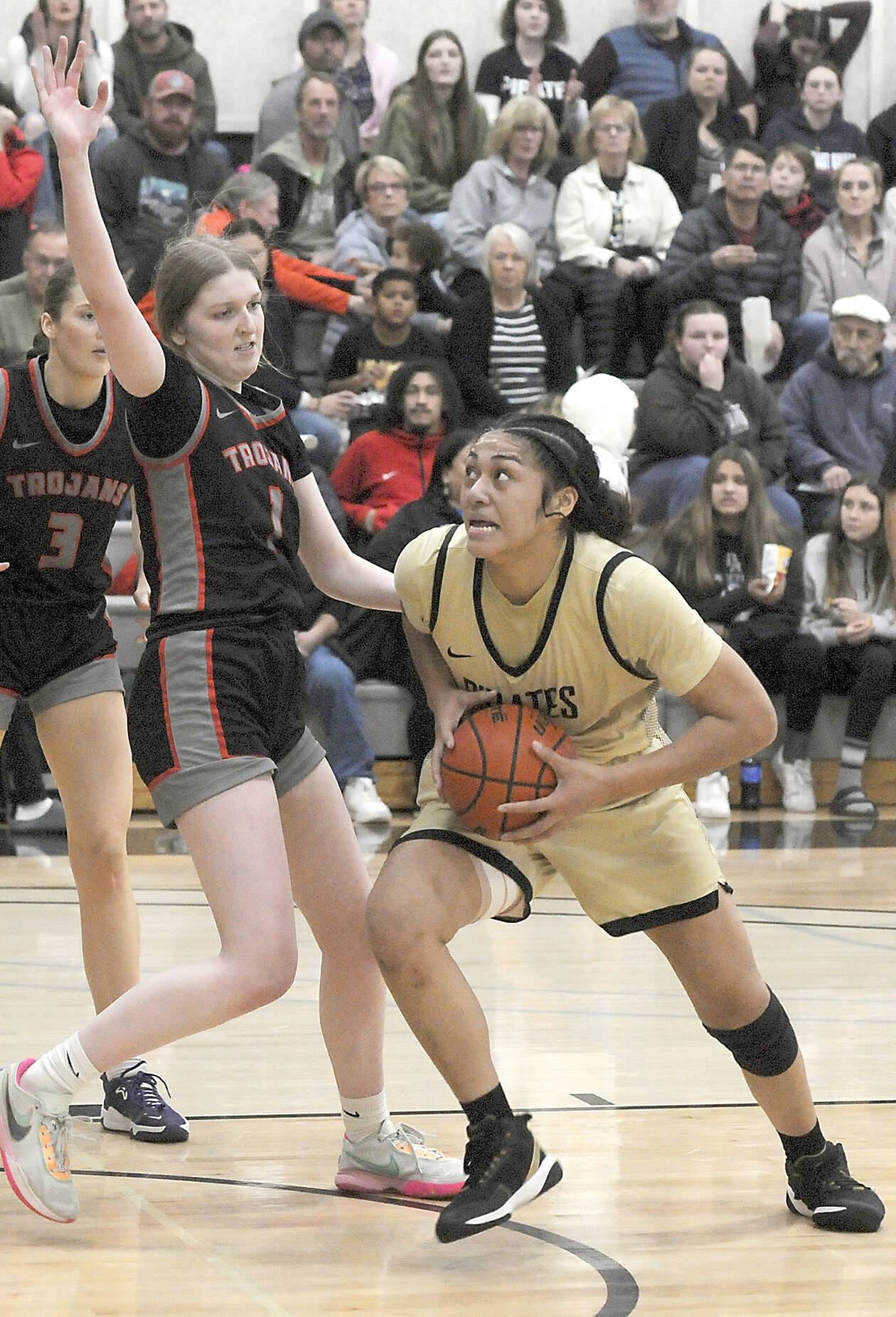 Peninsula’s Ituau Tuisaula, right, heads for the paint as Everett’s Lilly Frunk tries to hold her off on Wednesday night in Port Angele. (Keith Thorpe/Peninsula Daily News)