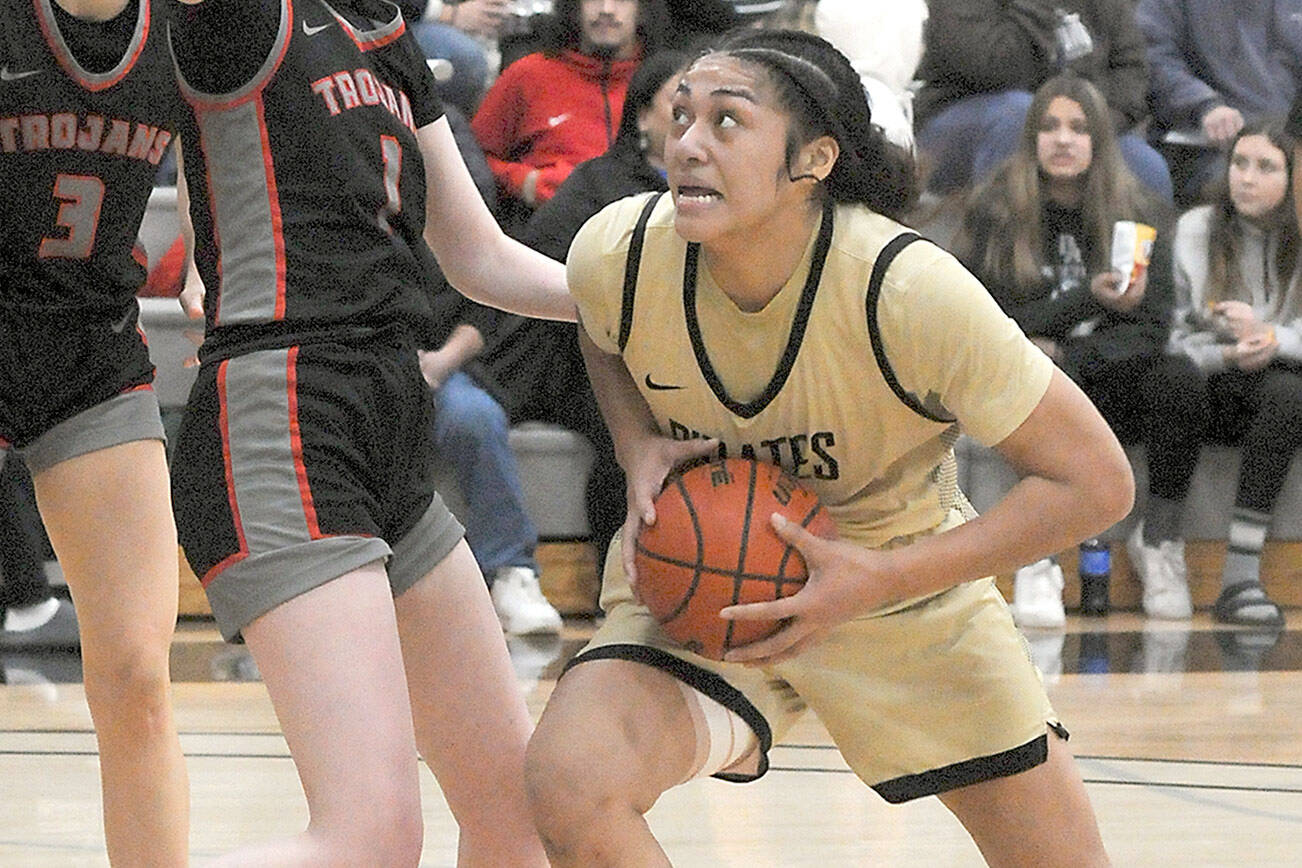 Keith Thorpe/Peninsula Daily News
Peninsula's Ituau Tuisaula, right, heads for the paint as Everett's Lilly Frunk tries to hold her off on Wednesday night in Port Angele.