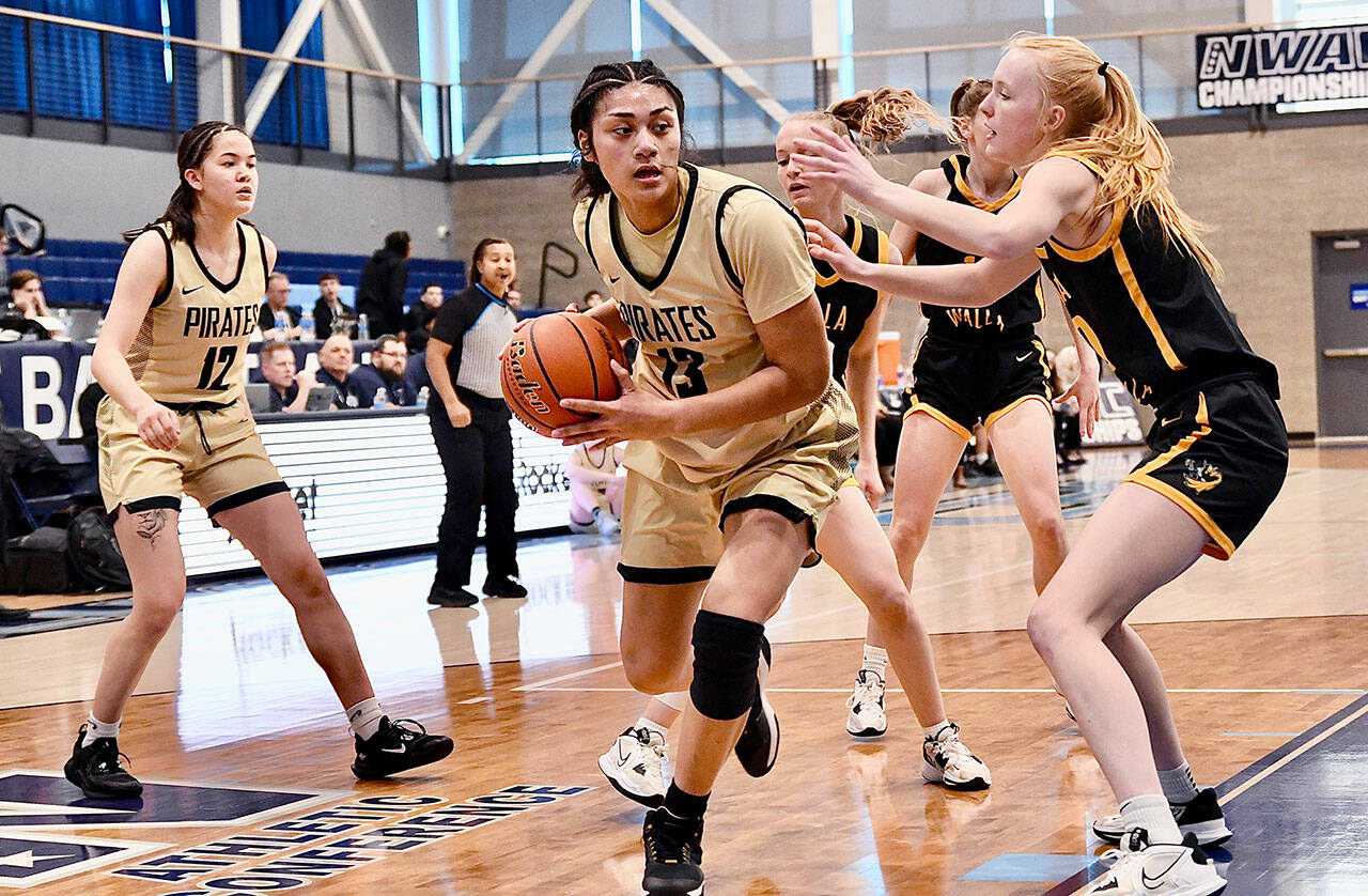 Jay Cline/for Peninsula College Peninsula’s Ituau Tuisaula works down low while guarded by a Walla Walla defender during the Pirates’ NWAC Women’s Basketball Tournament Quarterfinal on Friday at Columbia Basin College in Pasco.