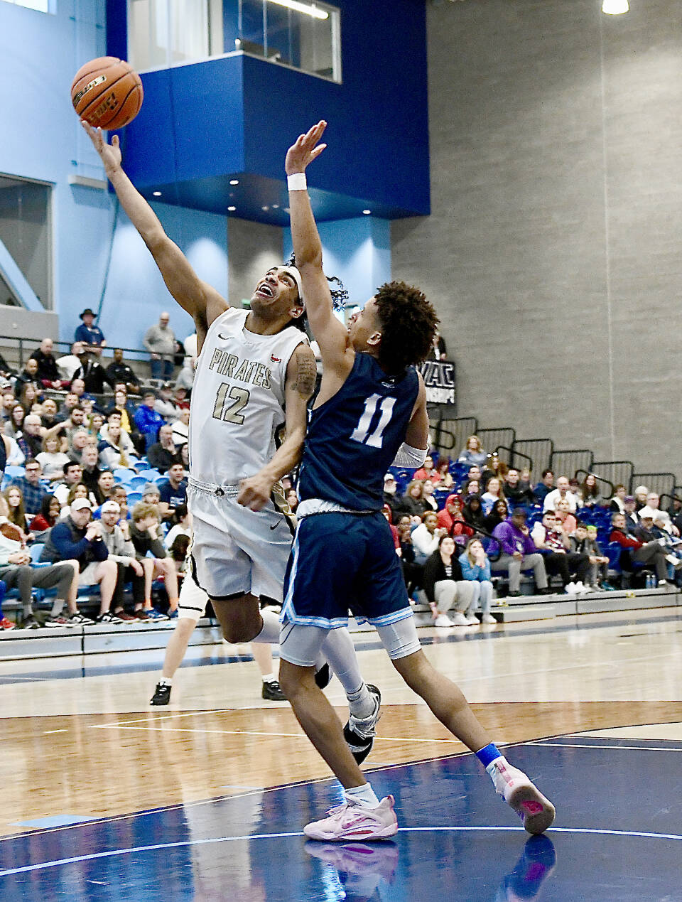 Peninsula College’s Roosevelt Williams Jr. goes up for a layup around Columbia Basin’s Ta’Veus Randle on Saturday in the NWAC tournament held in Pasco. Peninsula lost 77-73. (Jay Cline/Peninsula College)