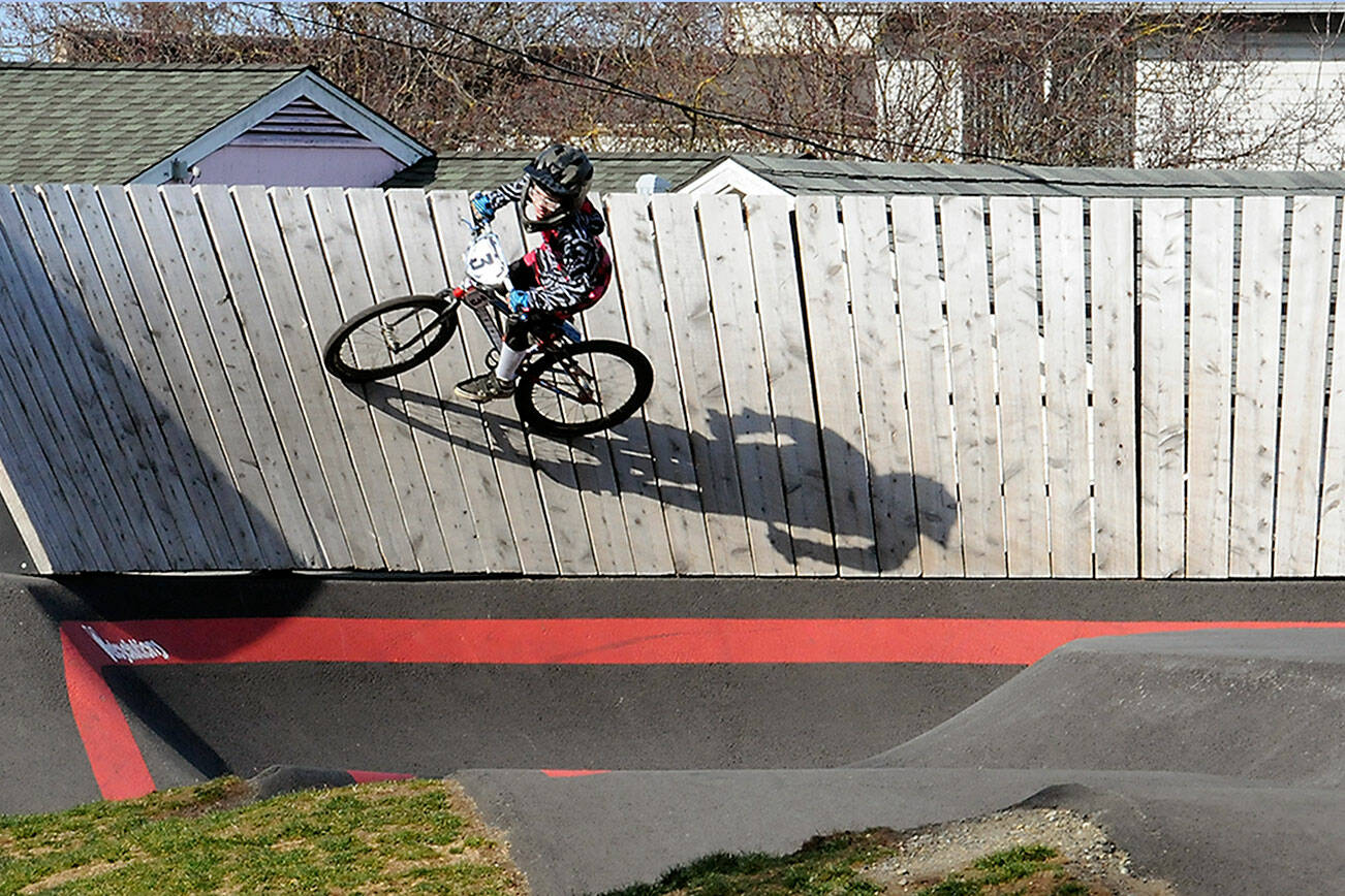 KEITH THORPE/PENINSULA DAILY NEWS
Mason Wilcox-Olton, 8, of Port Angeles casts a shadow on a high-banked curve at the Port Angeles Pump Track at Erickson Playfield on Wednesday. The track, the largest of its type in the Northwest, caters to a wide variety of wheeled conveyances and the first in the country to have an adaptive track element.