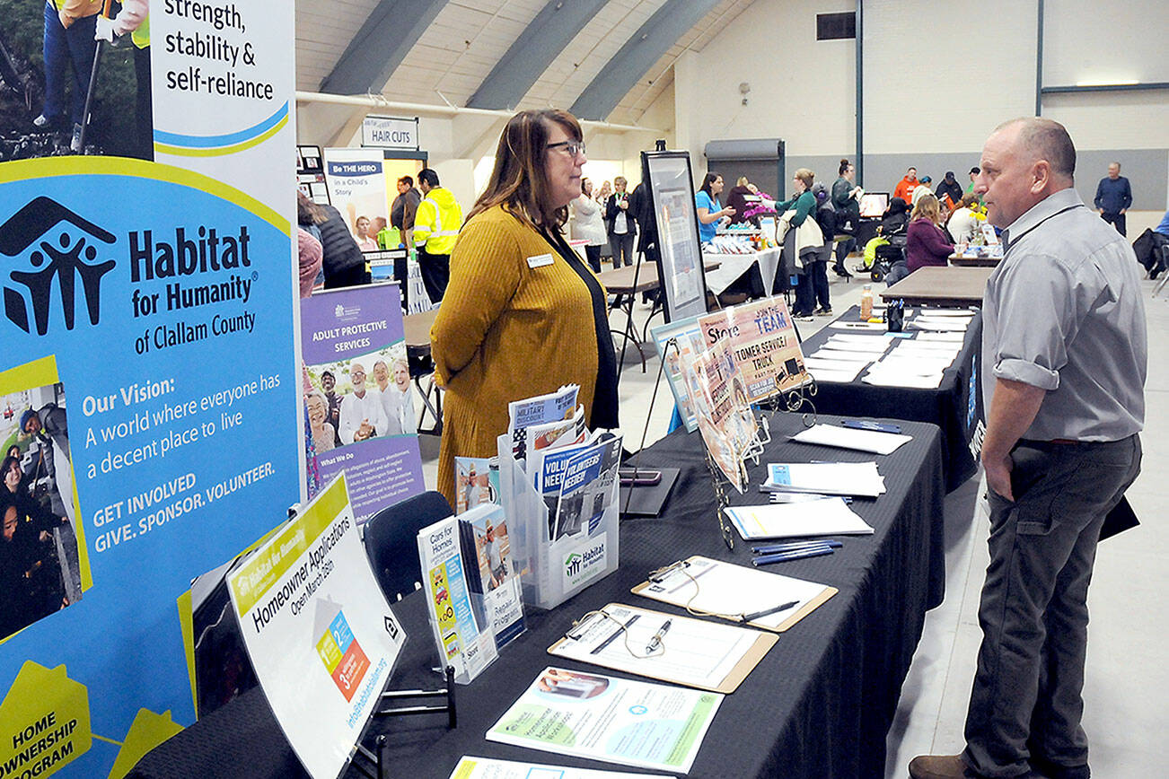 KEITH THORPE/PENINSULA DAILY NEWS
Brett Raemer of Port Angeles, right, speaks with Colleen Robinson, chief executive officer of Habitat for Humanity of Clallam County during Wednesday's Clallam County Job Fair at Vern Burton Community Center in Port Angeles. The fair, hosted by the Port Angeles Chamber of Commerce and sponsored by Olympic Medical Center, featured dozens of businesses and orgainztios offereing information on career opportinites on the North Olympic Peninsula.