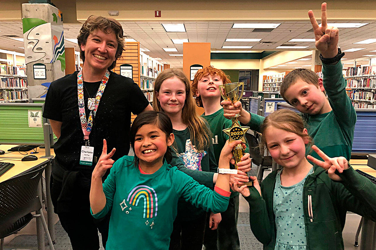 Photo courtesy of Five Acre School/ NOLS Librarian Charlotte McGrew stands with Five Acre School’s Team Kiwis, from second left, Emma Tran, Cascadia Cammett, Miles Taylor, Norah Madjdi-Pickett and Spencer Armstrong after they won the 2023 Battle of the Books.