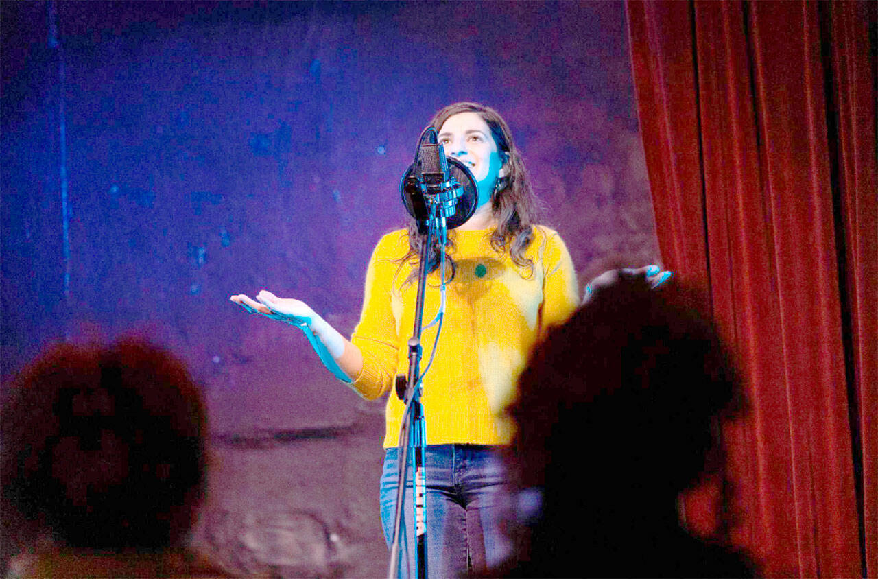 Elizar Mercado Nessa Goldman, host of the Out Loud Story Slam, tells a story at The Jewel Box Theatre in Poulsbo.