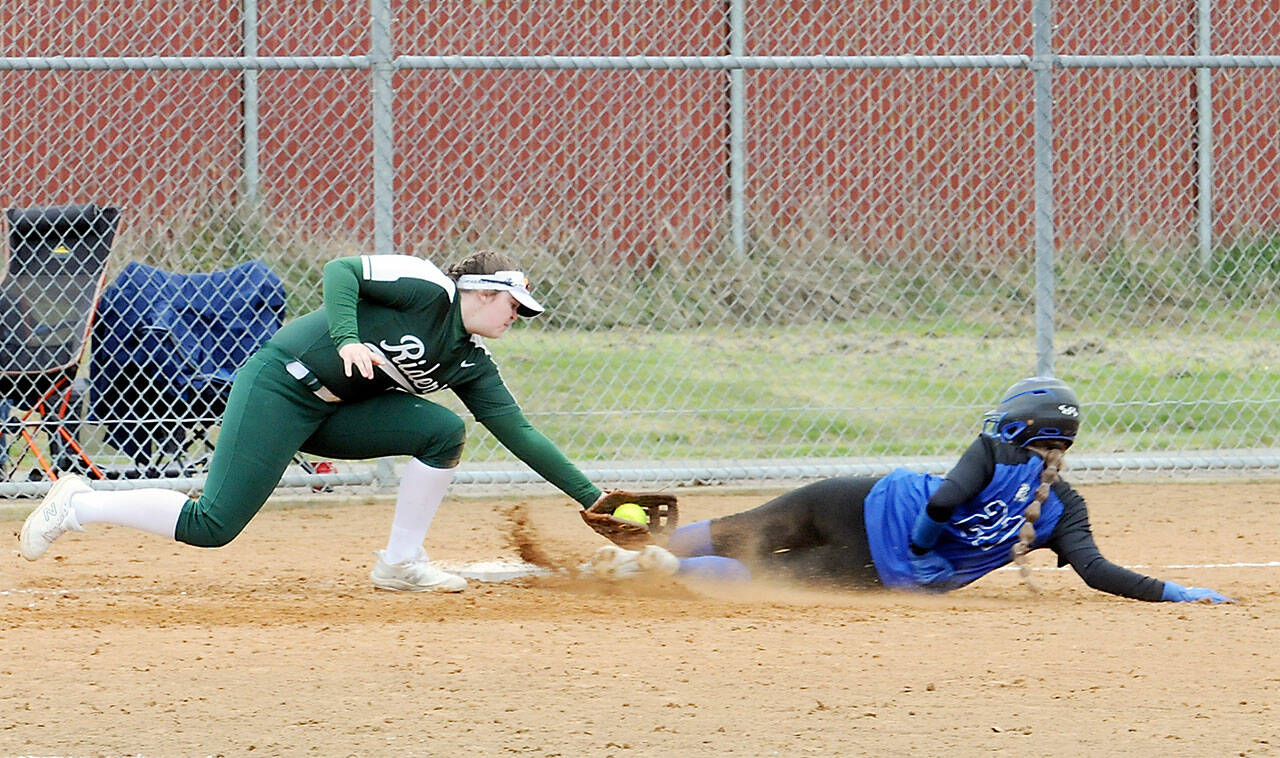 Port Angeles third baseman Taylor Worthington, left, tags out North Mason’s Adrianna Crowley to end the top of the fourth inning on Saturday at Dry Creek Elementary in Port Angeles. (Keith Thorpe/Peninsula Daily News)