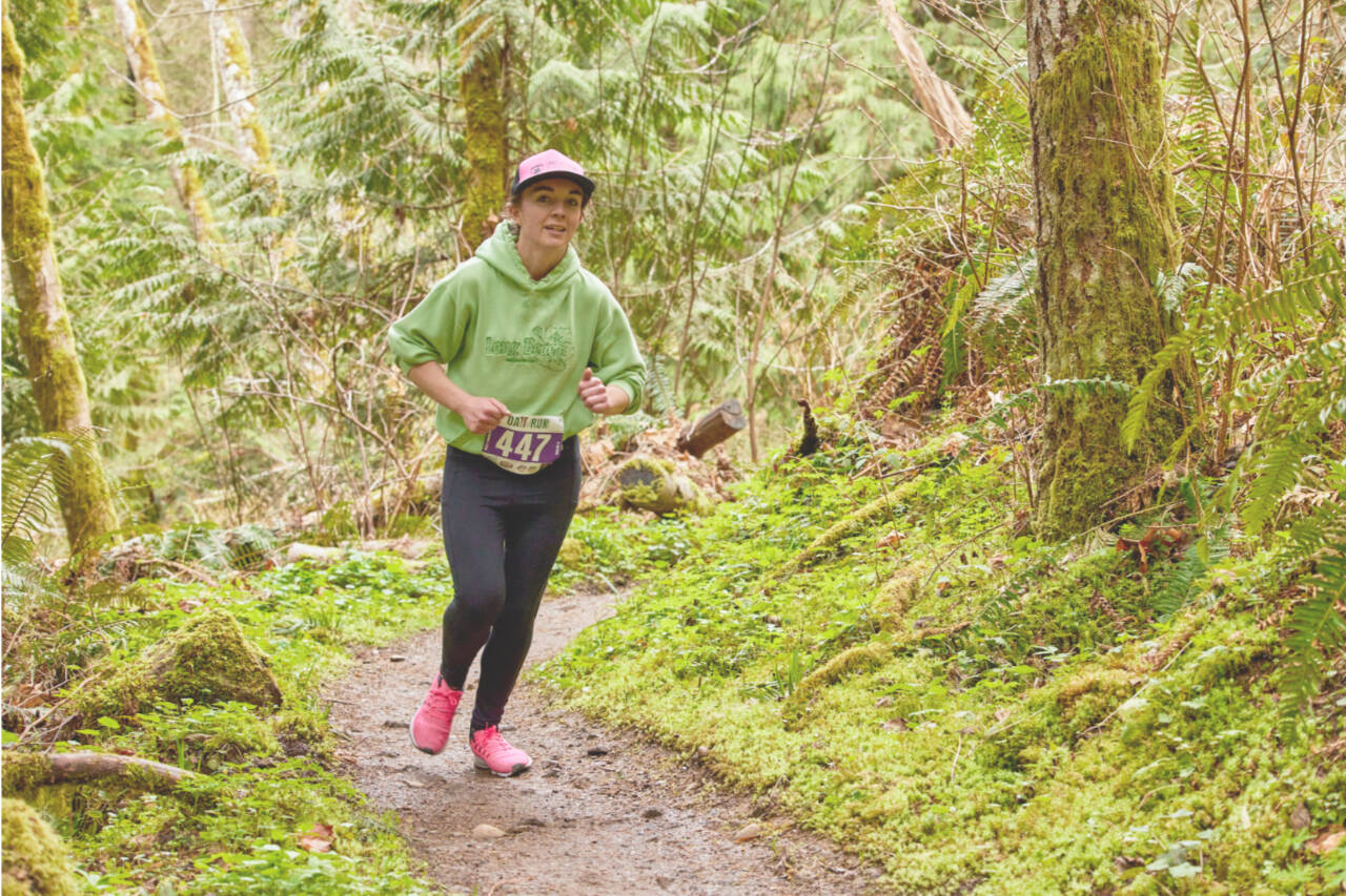 Marleigh Olson of Arlington runs in the half-marathon in the 10th annual OAT run held in the hills south of Joyce on Saturday. (Matt Sagen/Cascadia Films)