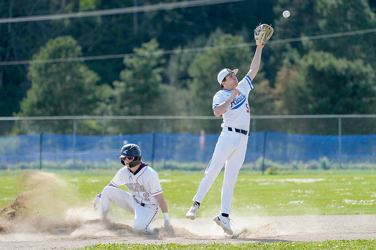 Sequim’s Zeke Schmadeke successfully steals second before the ball gets to Rivals’ second baseman Rylan Dunn during a game played in Chimacum on Tuesday. (Steve Mullensky/for Peninsula Daily News)