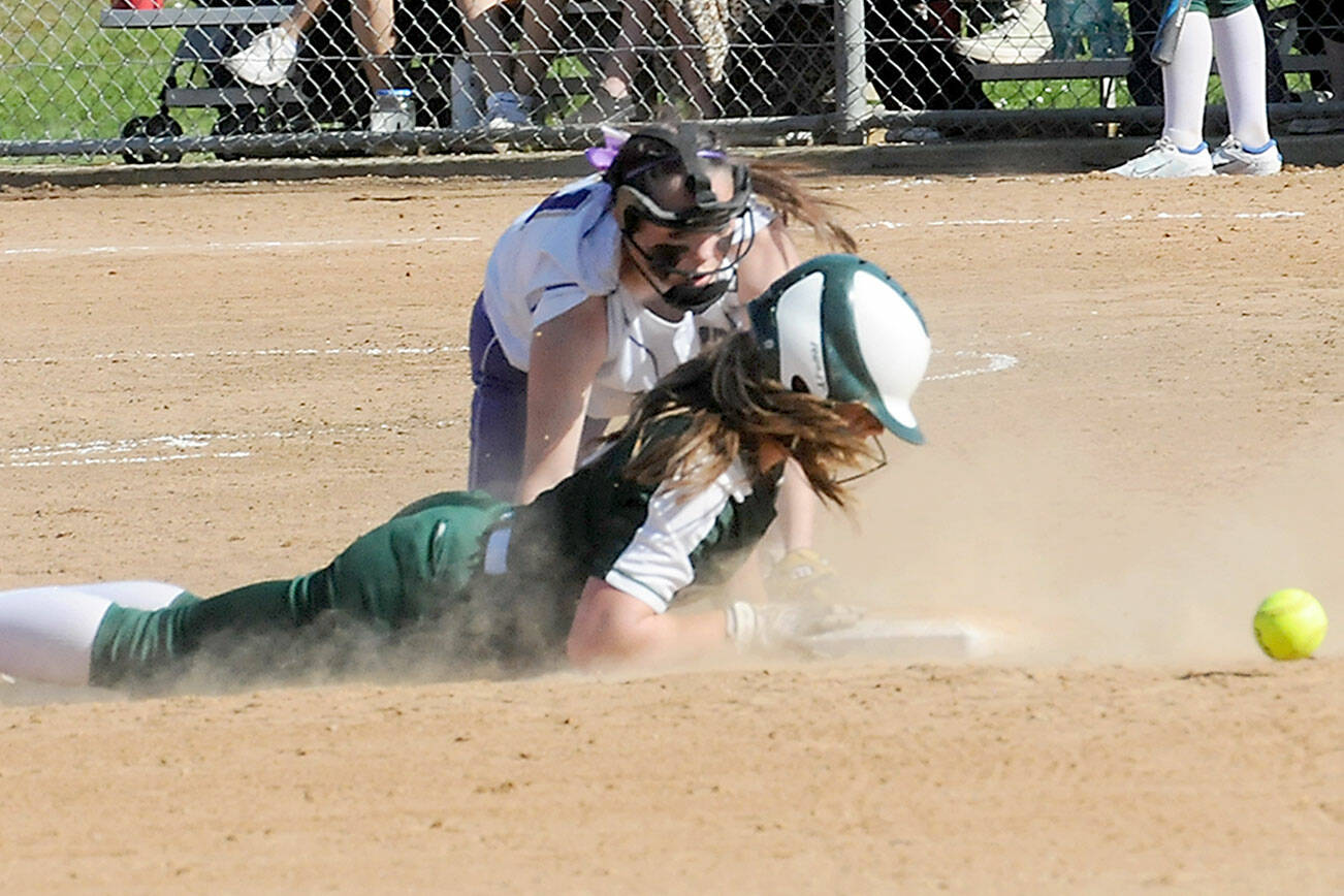 KEITH THORPE/PENINSULA DAILY NEWS
Port Angeles baserunner Lily Halberg makes a diving slide into second as the ball gets past Sequim shortstop Hannah Bates last week in Port Angeles. Both teams begin play in the bi-district tournament Friday.