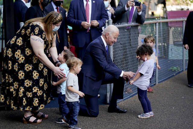 President Joe Biden greets the Washington Nationals' Racing