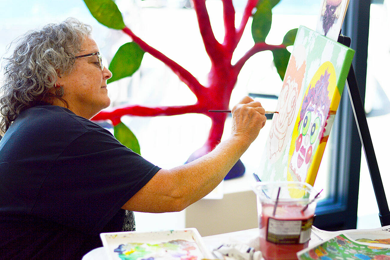 Virginia Ashby spent the afternoon of June 23 painting at Grover Gallery in Port Townsend, where her art is part of the "Psychedelic Summer" exhibition. photo courtesy of Northwind Art