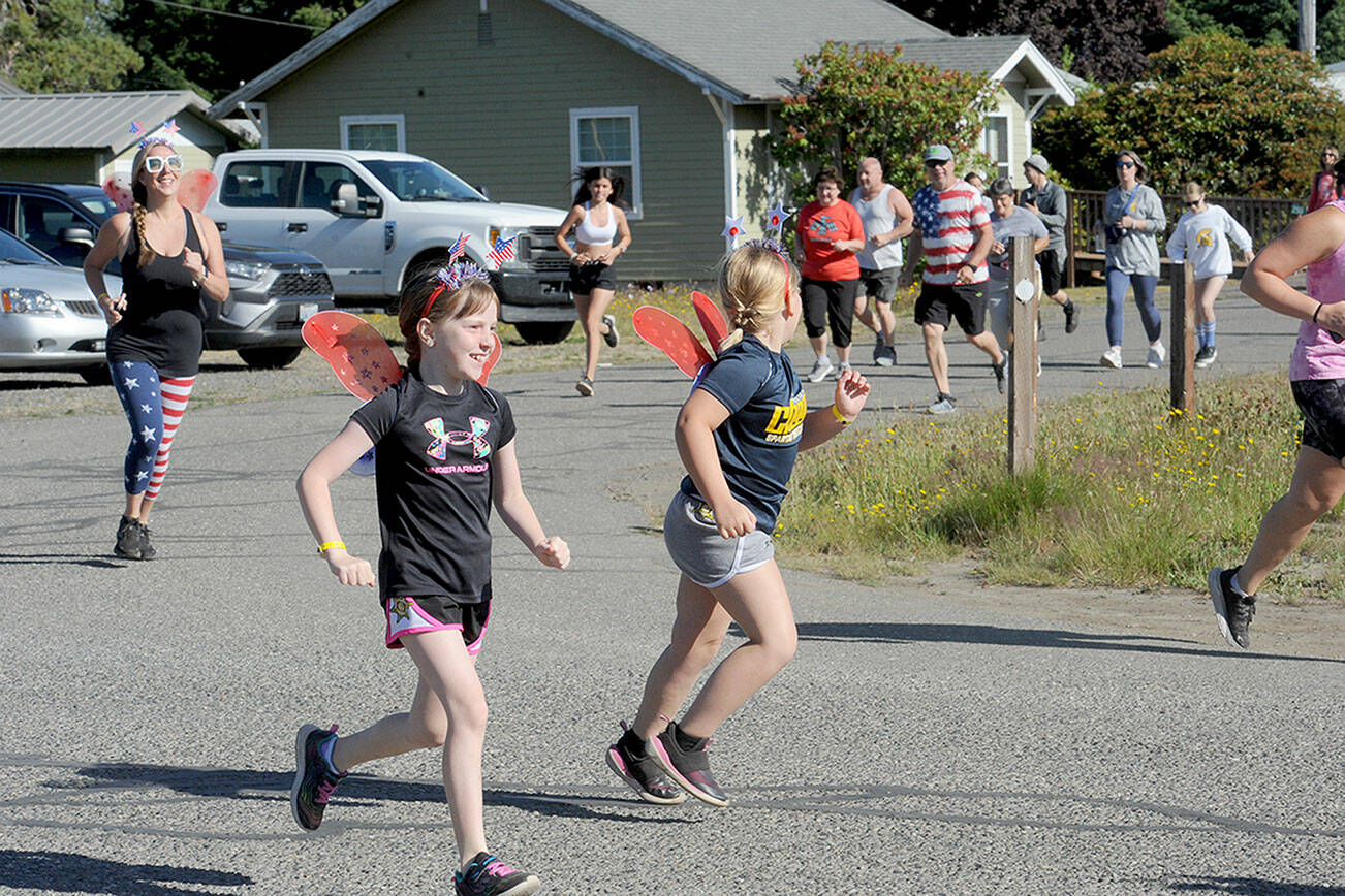 Runners are off and running at the annual Forks 4th of July Fun Run. About 100 participated. (Lonnie Archibald/for Peninsula Daily News)