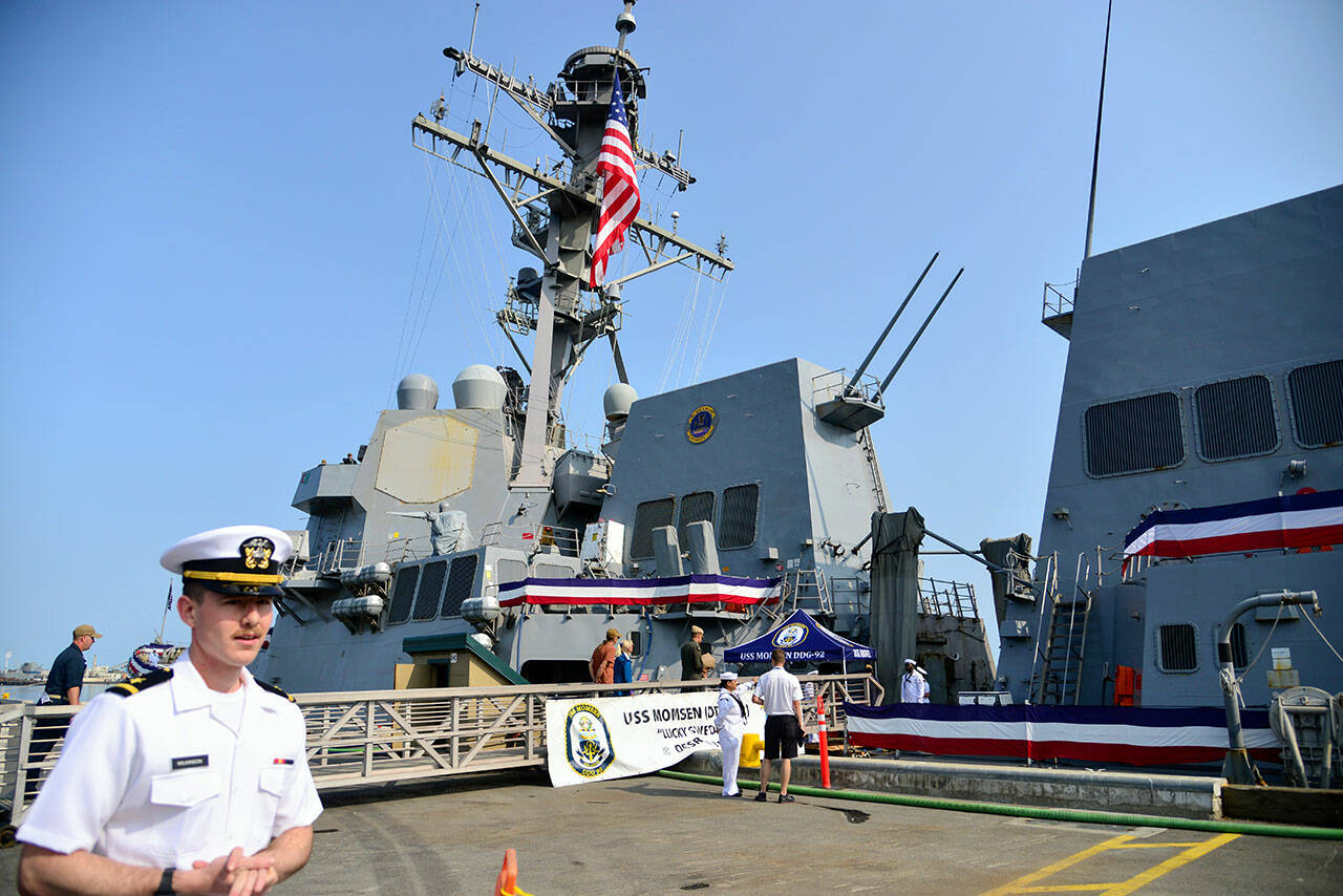 U.S. Navy Ensign Garrett Wilkinson welcomes visitors aboard the USS Momsen, which was in Port Angeles on Tuesday for the July 4 holiday. More than 1,000 people were lined up to tour the ship. (Peter Segall/Peninsula Daily News)