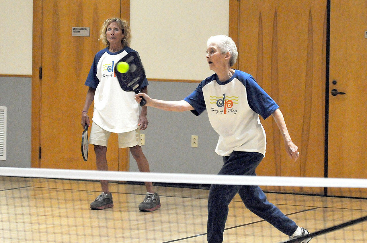 Nita Davidson, 85, of Port Angeles, front, and her teammate, Elyse Grosz, 72, of Port Angeles take on a game of pickleball on Saturday at the Port Angeles Senior Center, one of numerous venues for Day of Play, a celebration of recreational opportunities around the city. The event was arranged by the Port Angeles Parks and Recreation Department. (Keith Thorpe/Peninsula Daily News)