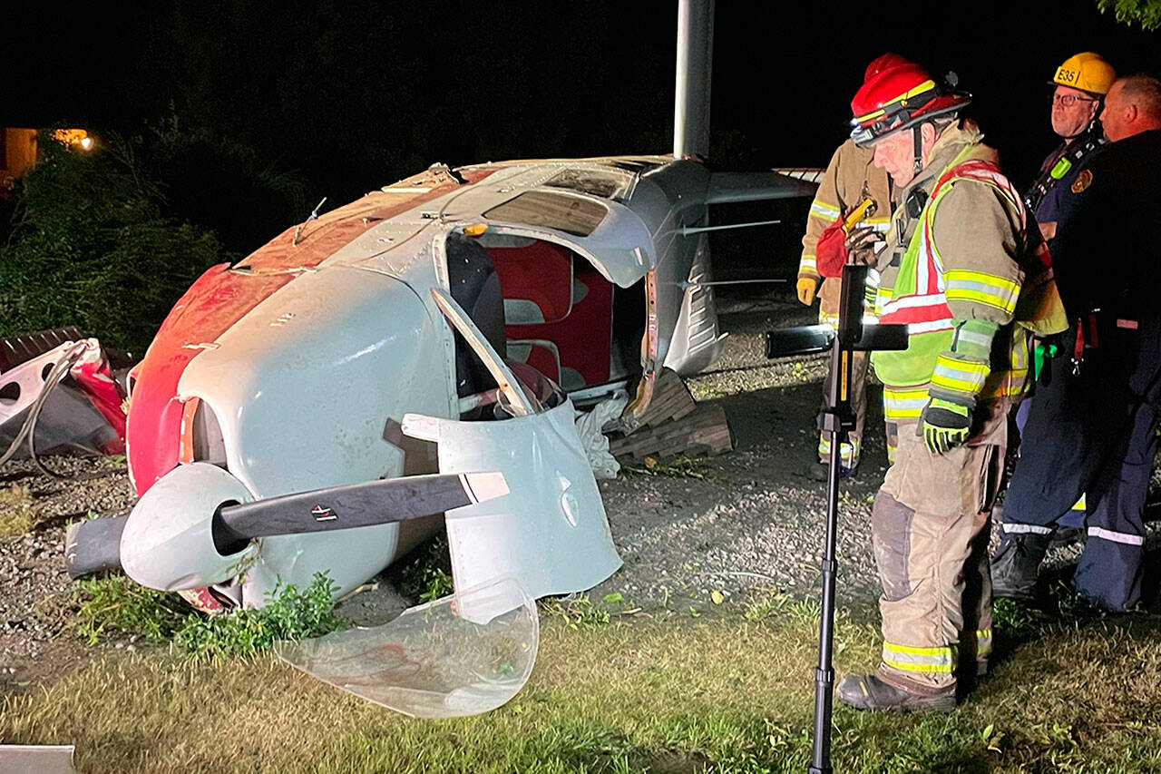 Firefighters with Clallam County Fire District 3 investigate a plane crash in Agnew on Saturday. Its passengers were transported with minor injuries to Olympic Medical Center in Port Angeles. (Matthew Nash/Olympic Peninsula News Group)