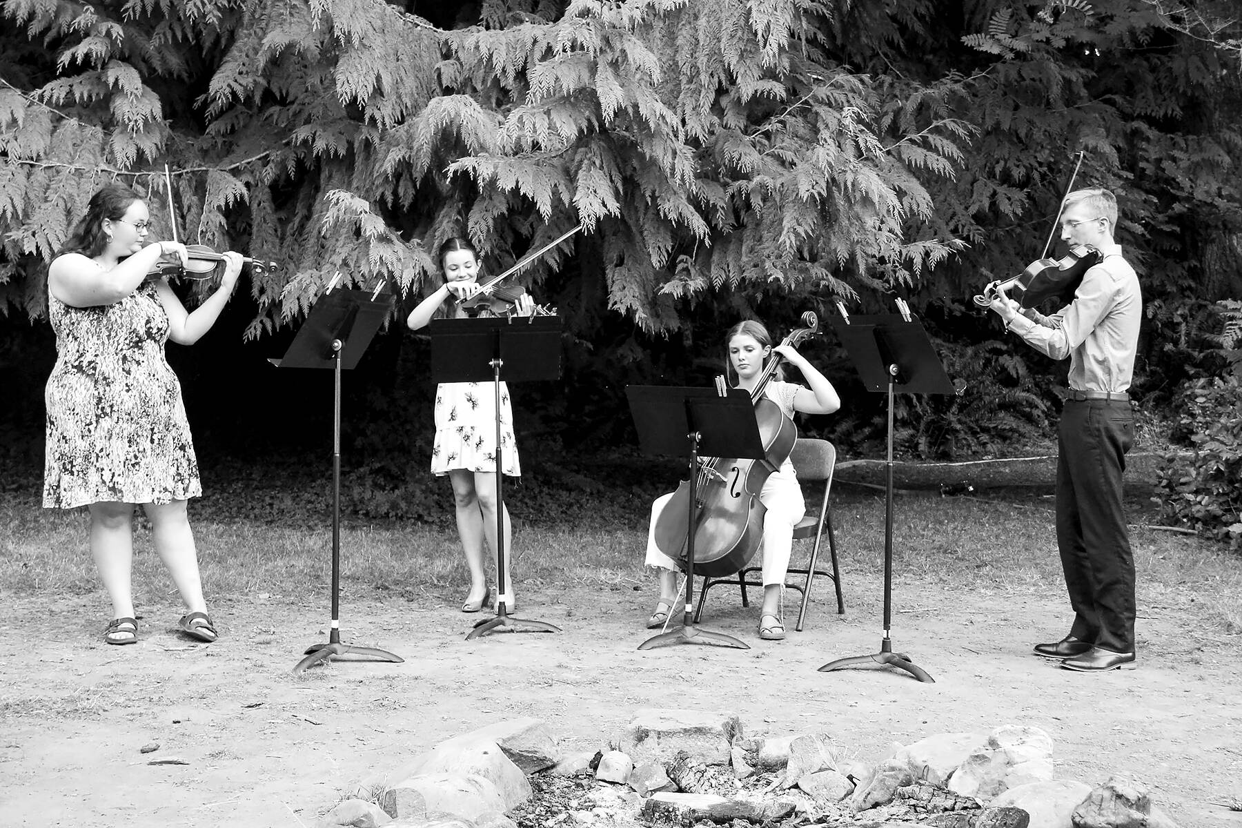 The Olympic Strings Workshop at Lake Crescent will present a free public concert Friday afternoon. Pictured during the 2022 camp are, from left, Marley Cochran, Courtney Smith, Jacklyn Minnoch and Luke Gavin. photo by Dewi Sprague/Olympic Strings Workshop