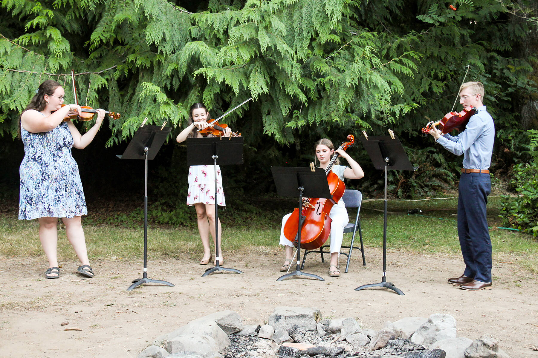 The Olympic Strings Workshop at Lake Crescent will present a free public concert Friday afternoon. Pictured during the 2022 camp are, from left, Marley Cochran, Courtney Smith, Jacklyn Minnoch and Luke Gavin. photo by Dewi Sprague/Olympic Strings Workshop