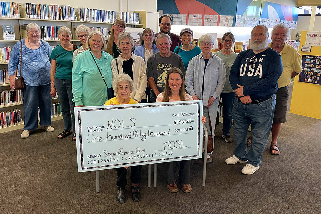 Matthew Nash/Olympic Peninsula News Group
Members of Friends of Sequim Library donate $150,000 on July 26 to the capital fund for the expansion and renovation of the Sequim Library project.