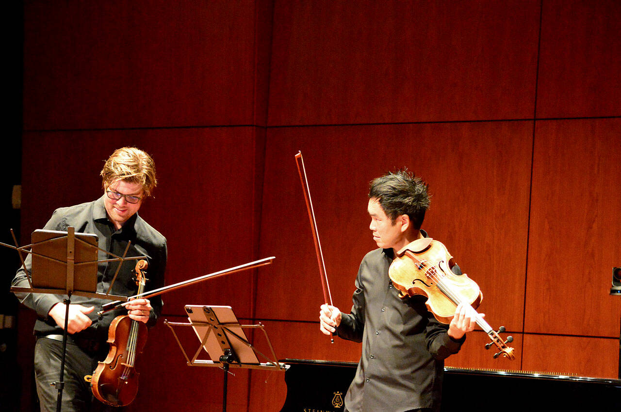 Music on the Strait cofounders James Garlick, left, and Richard O’Neill, pictured rehearsing, are bringing the festival to Field Arts & Events Hall and Maier Hall this week. (Diane Urbani de la Paz/For Peninsula Daily News)