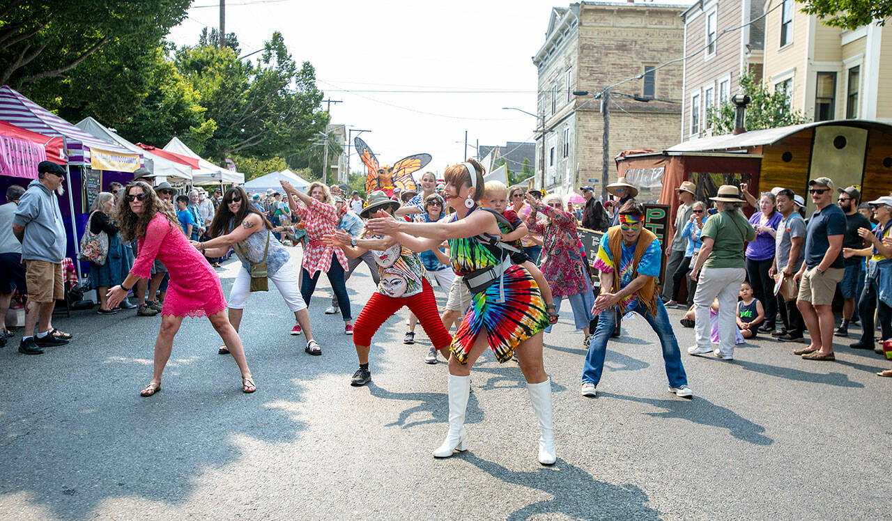 Zumba dancers perform on Lawrence Street during the Uptown Street Fair parade in Uptown Port Townsend on Saturday. Seventeen marching units, including this one, paraded down Lawrence Street in front of hundreds of spectators lining the sidewalk. (Steve Mullensky/for Peninsula Daily News)