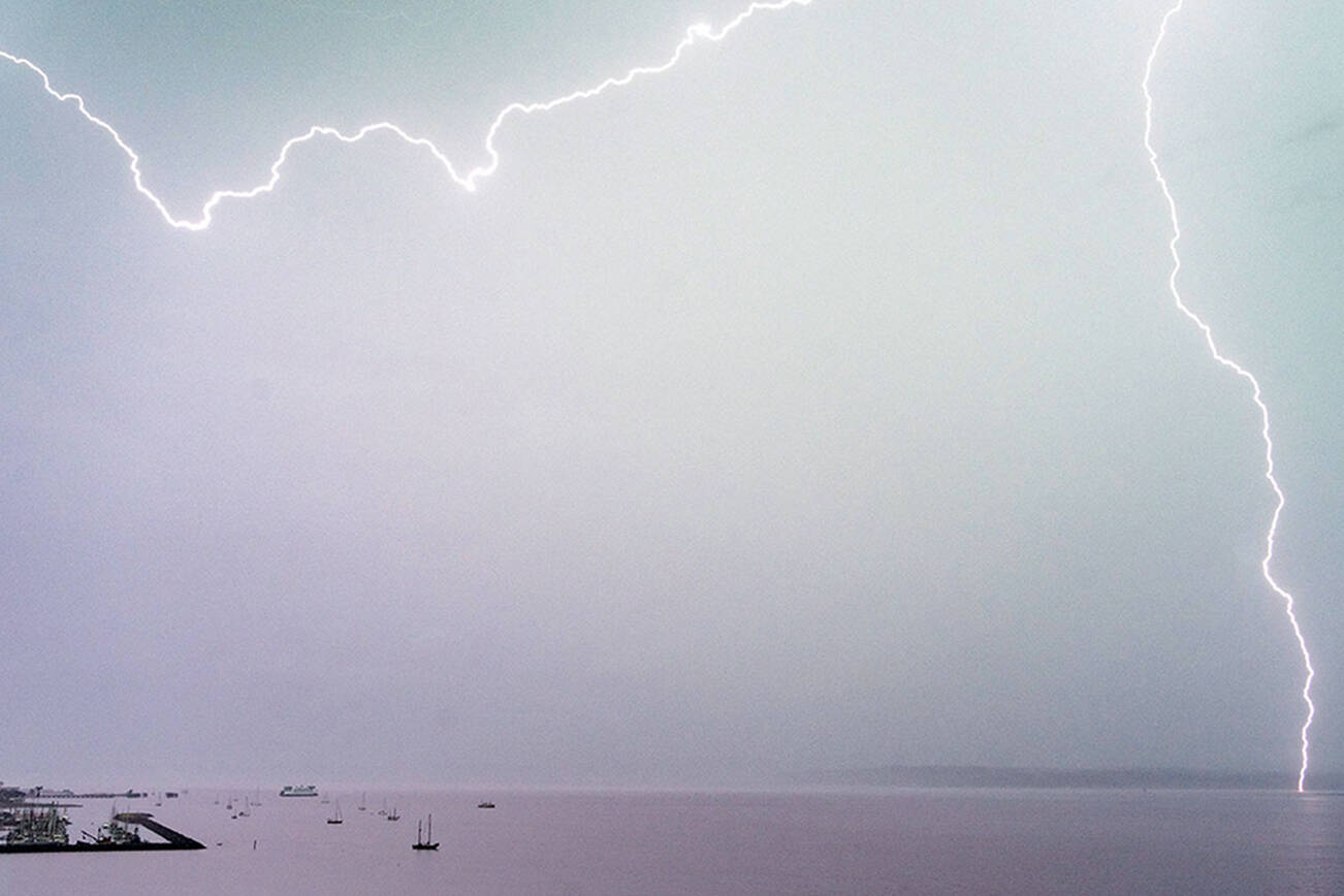 Lightning streaks across Port Townsend Bay on Tuesday afternoon. (Steve Mullensky/for Peninsula Daily News)