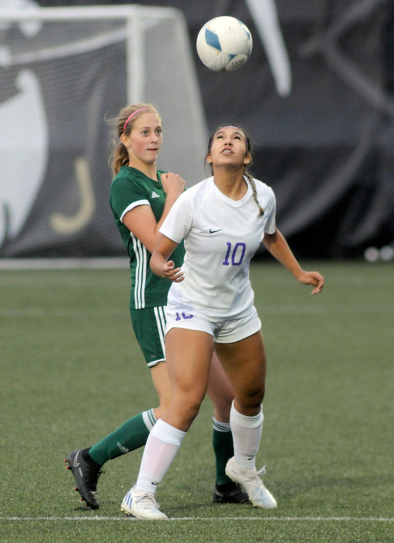 Sequim’s Jennyfer Gomez, front, takes a header in front of Port Angeles’ Becca Manson last year at Wally Sigmar Field in Port Angeles. Gomez, a second-team all-Olympic League selection, is back this year as a strong midfielder for the Wolves. (Keith Thorpe/Peninsula Daily News)