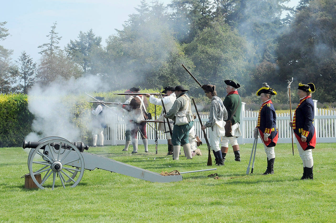 A collection of American militiamen fire upon English Redcoats during a mock skirmish at the Northwest Colonial Festival near Agnew on Saturday. The event, hosted by the George Washington Inn, featured historical displays and interpretations of life during the Revolutionary War era. (Keith Thorpe/Peninsula Daily News)