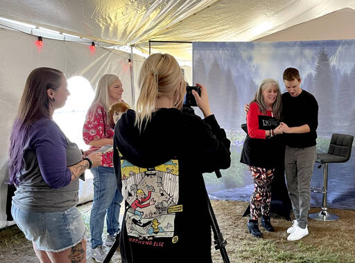 Actor Erik Odom, a Forever Twilight in Forks Festival regular, and a Very Important Twilighter (VIT) ticketholder prepare for a professional photo at the actor’s signing event on Friday at Tillicum Park. VITs passed through the big tent, meeting Odom as well as Ashley Greene and Rachelle Lefevre. The Twilight series actors greeted ticketholders and signed books and other memorabilia. Volunteers also were in place to take extra photos with the VIT’s cameras/phones. (Christi Baron/Olympic Peninsula News Group)