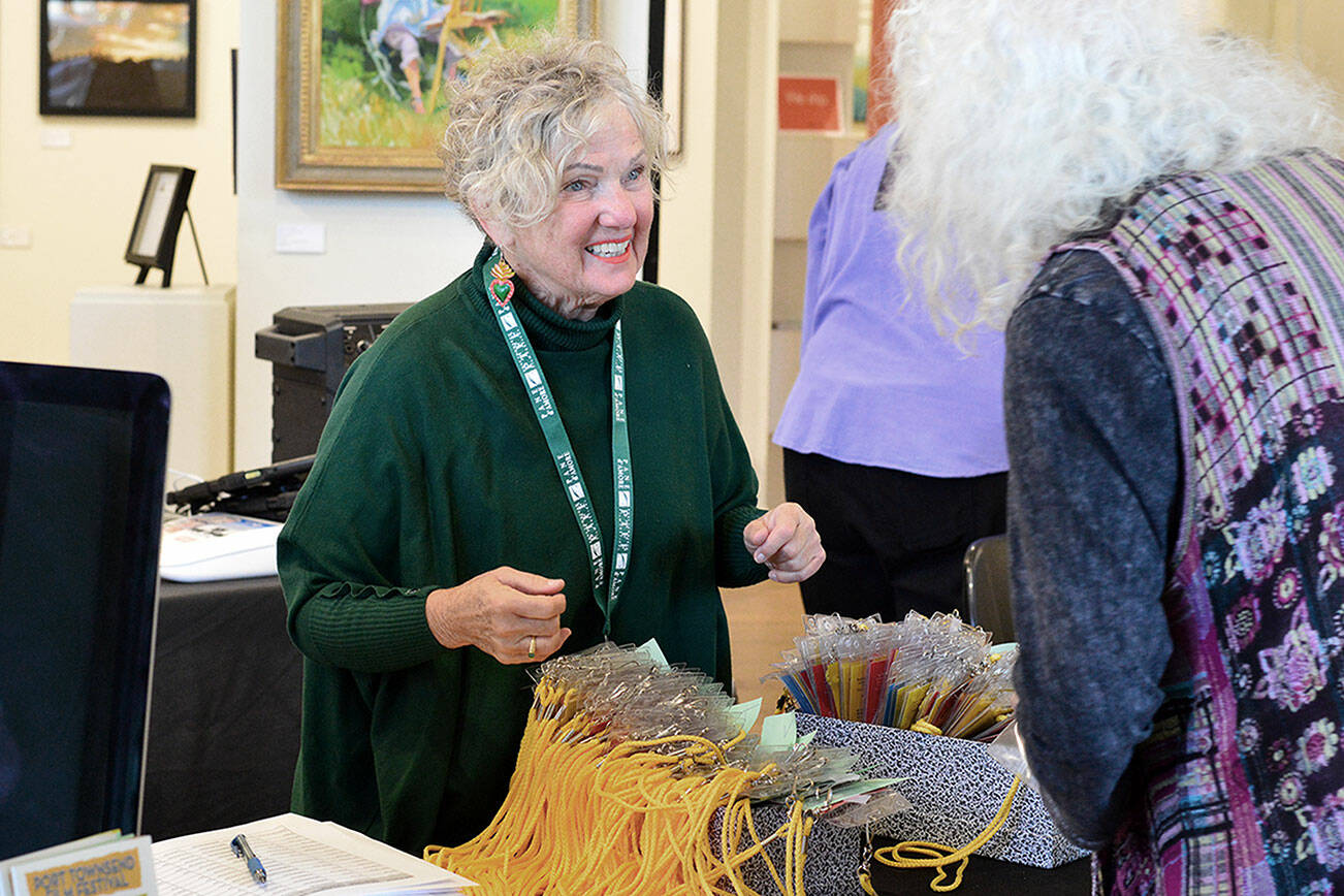 Port Townsend Film Festival volunteer Terry Wagner greets one of more than 700 festival passholders on Thursday. The festival is happening throughout the weekend at multiple venues in downtown Port Townsend; information is found at ptfilmfest.com. photo by Diane Urbani de la Paz/For Peninsula Daily News