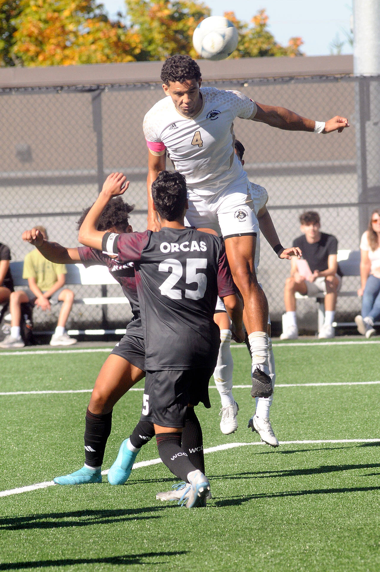 Peninsula’s Fin Moutune, top, takes the header above Whatcom’s Eduardo Rocha, front, and Josiah Dupree on Saturday in Port Angeles. (Keith Thorpe/Peninsula Daily News)