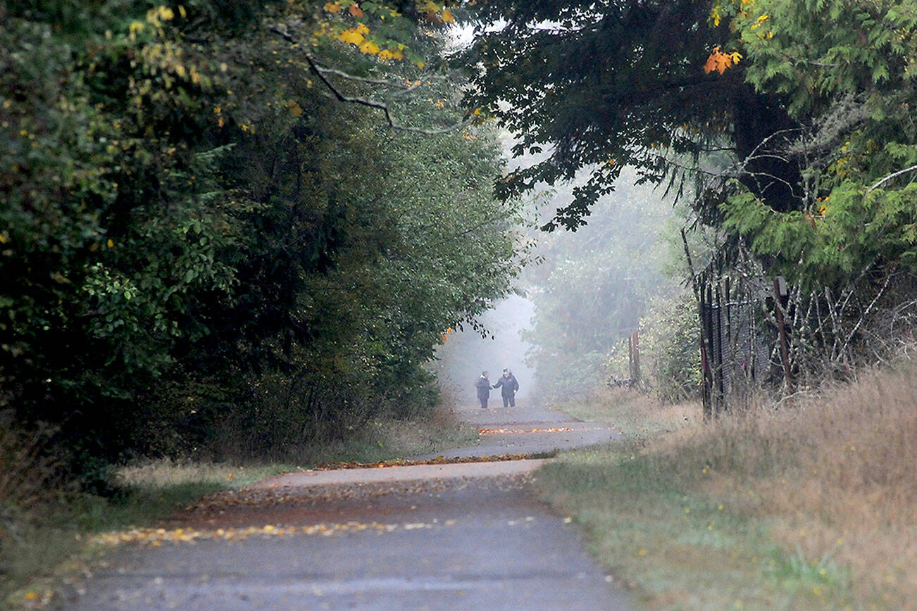 Walkers make their way along a foggy portion of the Olympic Discovery Trail near William R. Fairchild International Airport in Port Angeles. Areas of fog covered many portions of the North Olympic Peninsula on Thursday with wetter weather forecast for the weekend. (Keith Thorpe/Peninsula Daily News)