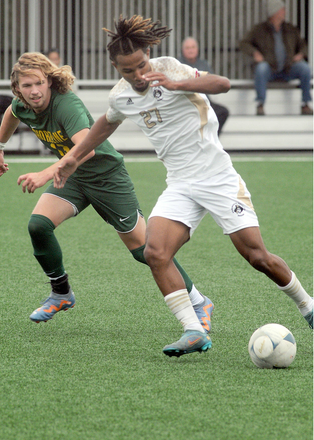 Peninsula’s Abdurahim Leigh, right, dribbles past Shoreline’s Brennon Odonnell during Saturday’s match in Port Angeles. Leigh had two goals and an assist in the game, a 7-0 Peninsula win. (Keith Thorpe/Peninsula Daily News)