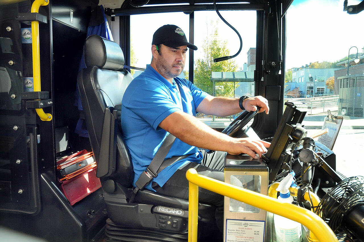 Clallam Transit driver Dante Ruiz prepares his bus for the 30 Route to Sequim on Wednesday at The Gateway transit center in Port Angeles. (Keith Thorpe/Peninsula Daily News)