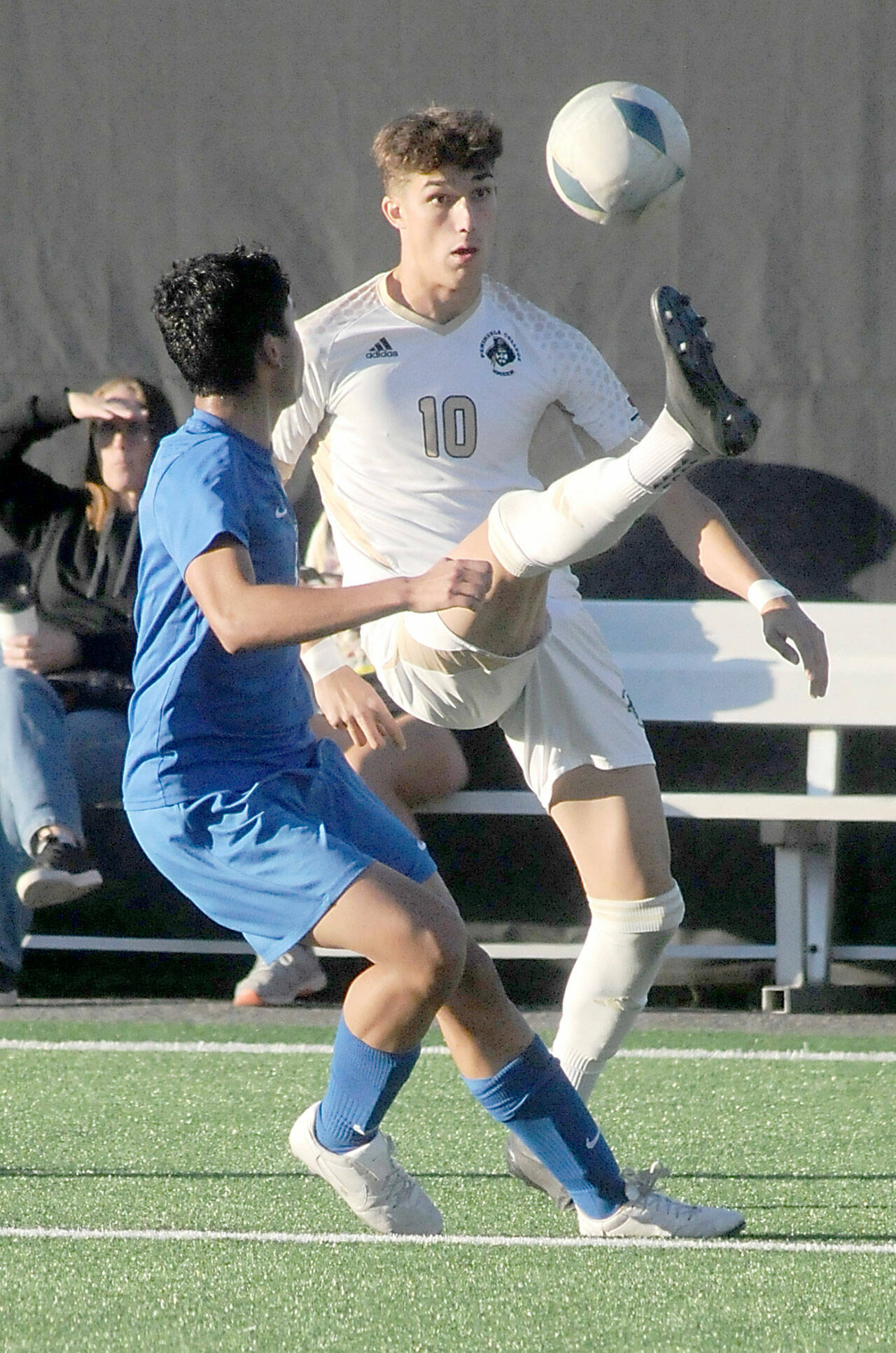 Peninsula’s Nil Grau gives a high kick to keep the ball out of reach of Edmond’s Enzo Buenaventura during Wednesday’s match in Port Angeles. (Keith Thorpe/Peninsula Daily News)