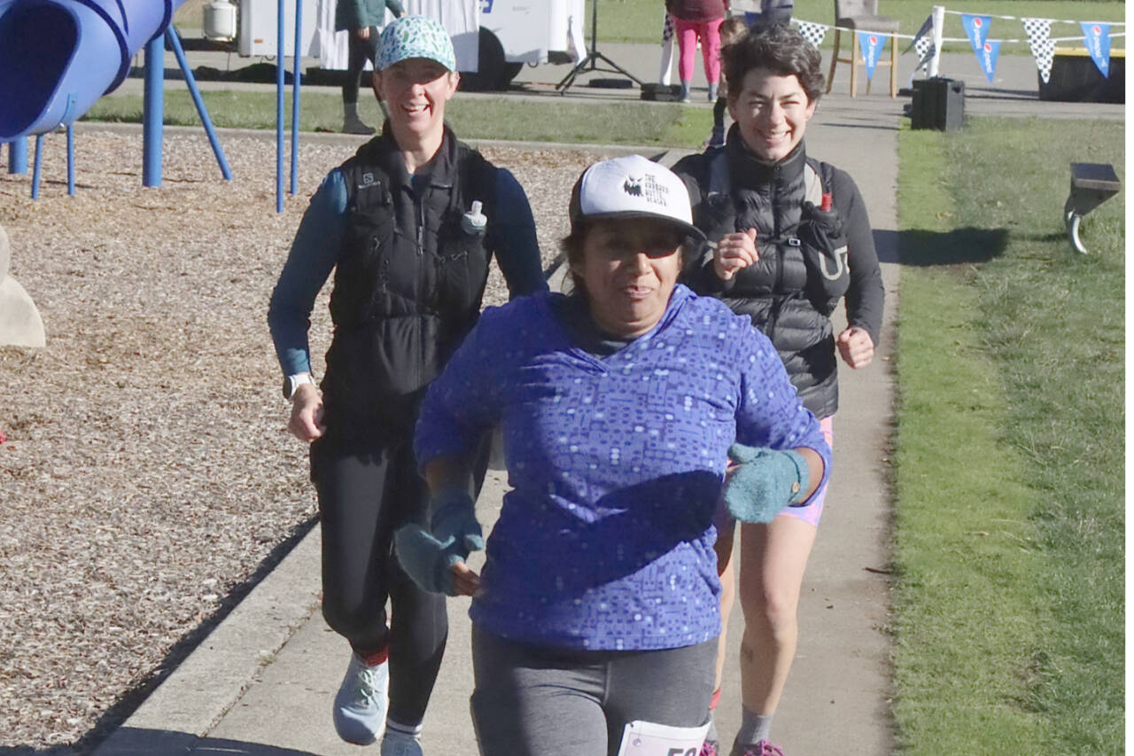 From left, Christine Buchanan from Camano Island, Michele Harmeling from Palmer, Alaska, and Elizabeth Castillo from Tacoma run in the Salt Creek 24 event held this weekend at the Salt Creek Recreation Area. More than $7,000 was raised during the charity event. (Dave Logan/for Peninsula Daily News)