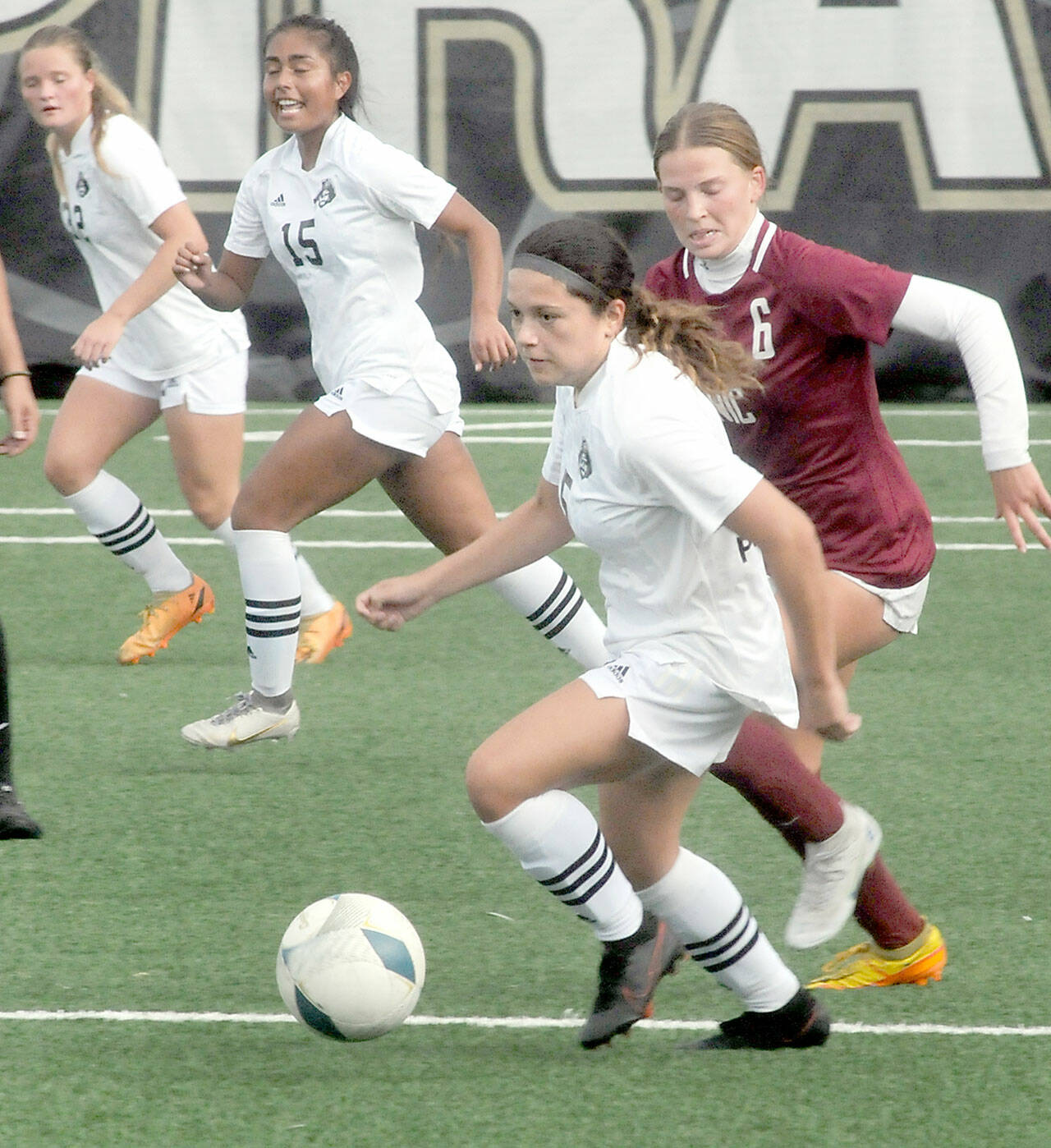 Peninsula’s Taya Bohenko, front, races past North Idaho’s Mariel Stuart as Bohenko’s teammates, Gemma Rowland and Alexia Rodriguez-Burdeaux follow behind during Saturday’s NWAC quarterfinal match in Port Angeles. (Keith Thorpe/Peninsula Daily News)