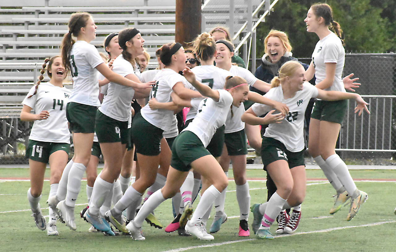 The Port Angeles girls soccer team celebrates beating Enumclaw in penalty kicks and qualifying for the state 2A tournament. (Kevin Hanson)