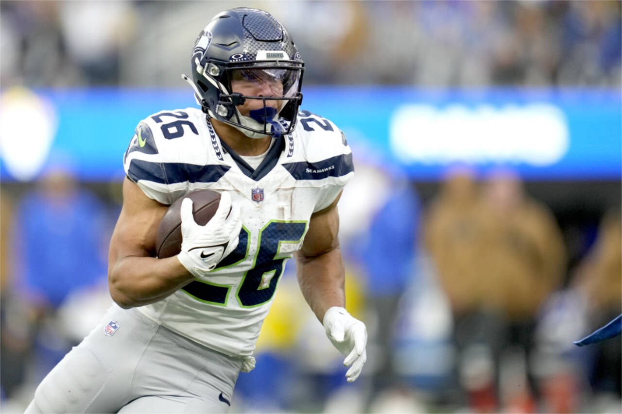 Seattle Seahawks running back Zach Charbonnet (26) runs the ball during the second half of an NFL football game against the Los Angeles Rams on Sunday in Inglewood, Calif. (Ashley Landis/The Associated Press)