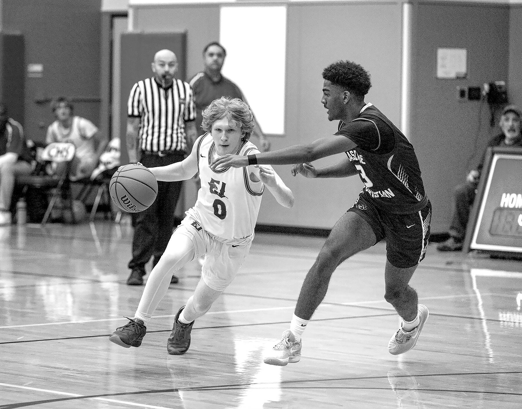 Steve Mullensky/for Peninsula Daily News

Rivals' Tracycen Brown, #3, gets around the block of Cascade Christian's Josiah Gopaul during a Thursday night home game played in Chimacum.