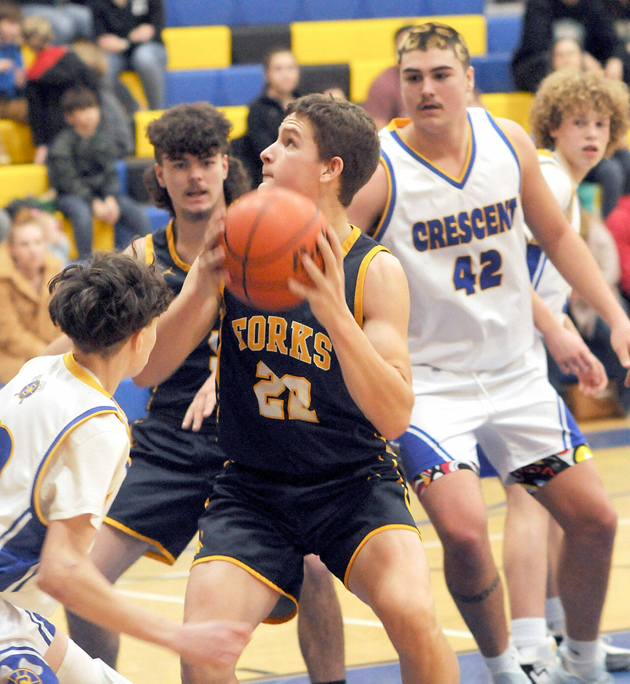 Forks’ Brody Lausche, center, playing against Crescent last year, looks to be one of the mainstays for the Spartans in the post this year. (Keith Thorpe/Peninsula Daily News)