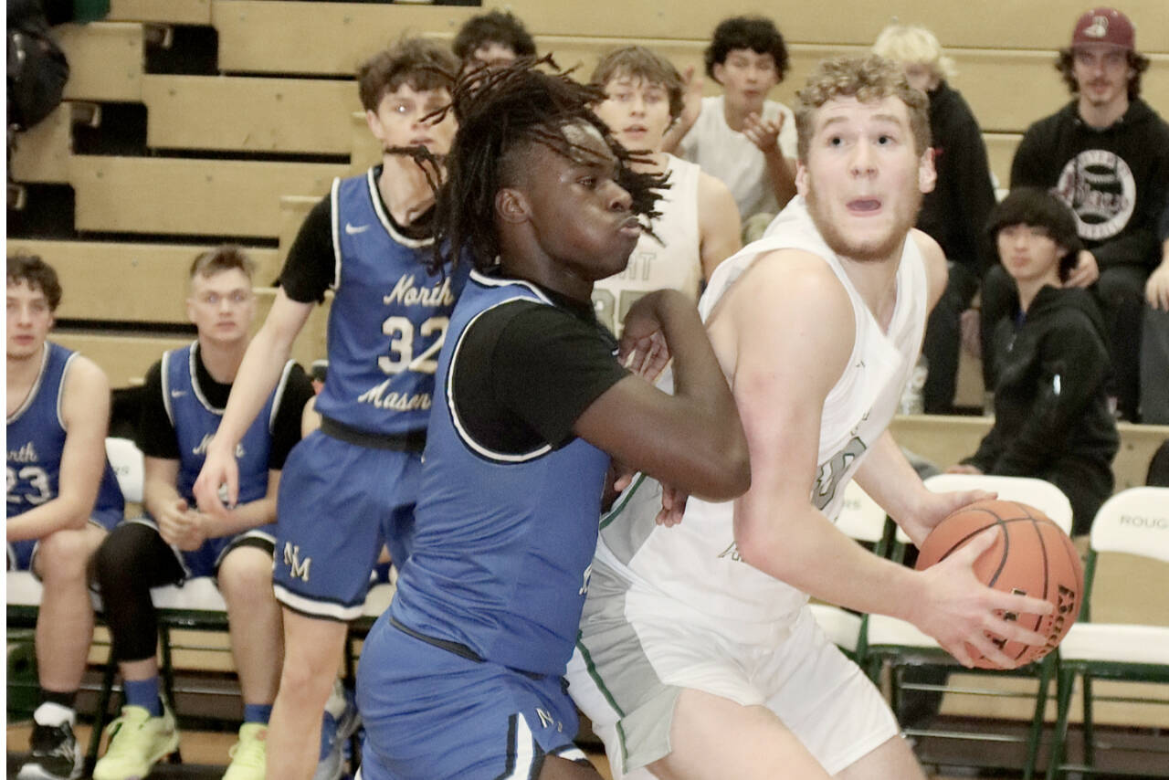 Port Angeles’ Isaiah Shamp fights to get off a shot against North Mason’s Andrew Littrean on Tuesday night in Port Angeles. Shamp finished with 17 points in a 92-57 victory. (Dave Logan/for Peninsula Daily News)