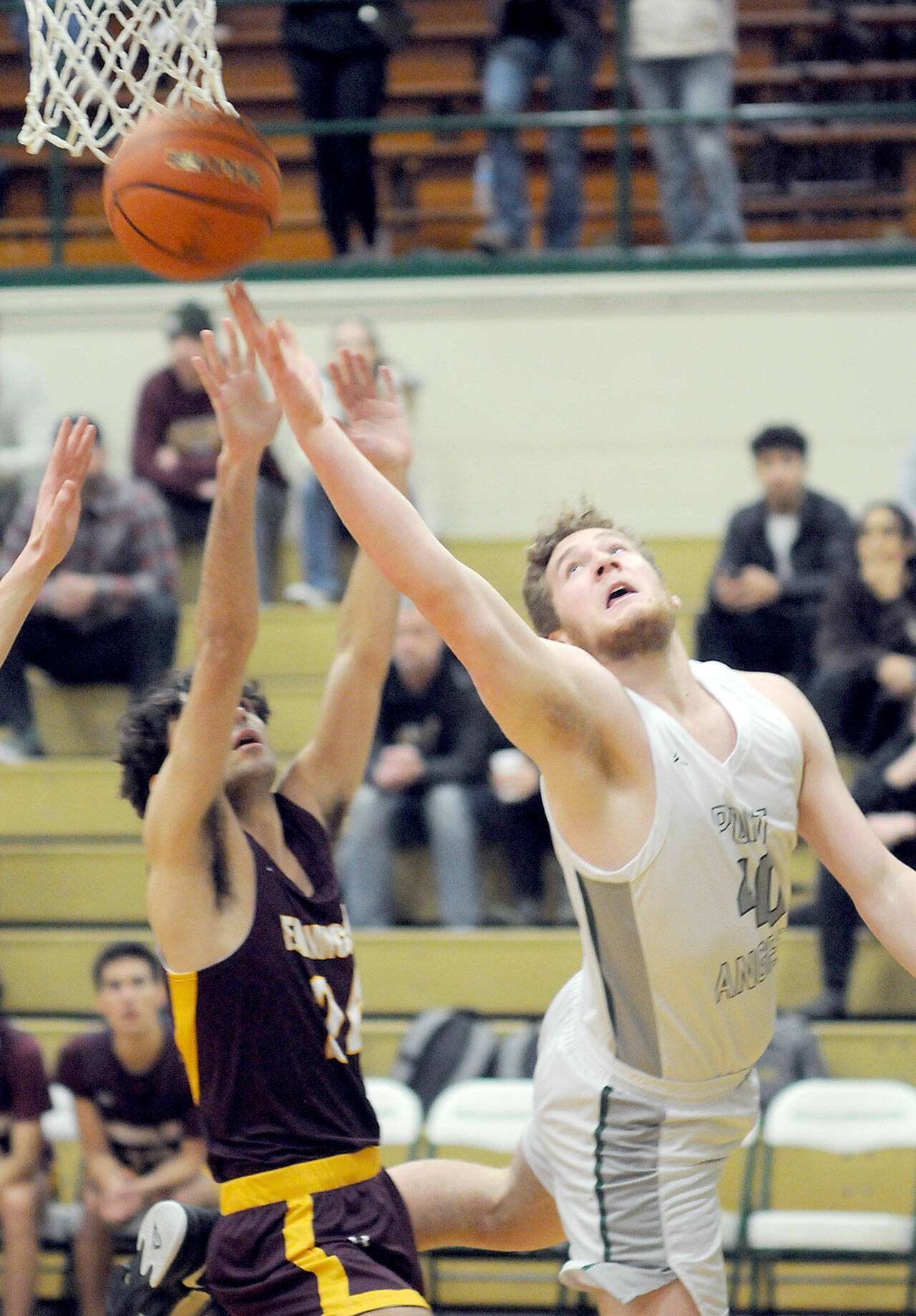 Port Angeles’ Isaiah Shamp, right, goes for the quick layup over the head of Enumclaw’s Austin Pierce on Wednesday at Port Angeles High School. (Keith Thorpe/Peninsula Daily News)