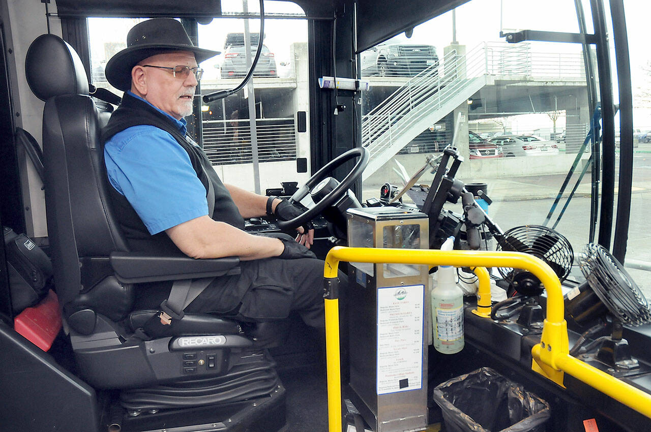 Clallam Transit driver Duane Benedict looks down at his fare box before departing The Gateway transit center in downtown Port Angeles on Saturday — the last day of collecting fares on most bus routes. (Keith Thorpe/Peninsula Daily News)
