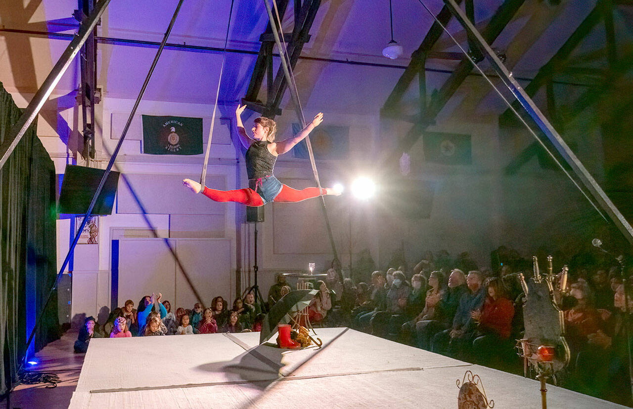 Juliane Hall of Seattle performs acrobatics on the straps during the First Night circus on Sunday at the American Legion Hall in Port Townsend. The Production Alliance created an all-ages experience for New Year’s Eve. (Steve Mullensky/for Peninsula Daily News)