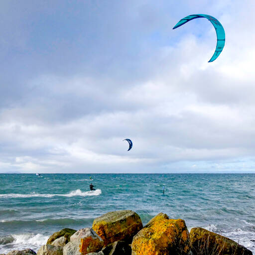 A kiteboarder uses the wind on Saturday at Cline Spit near Sequim. More windy conditions are expected today with gusts up to 50 mph expected across the Peninsula, followed by very cold temperatures forecast through the weekend. (Steve Jones)