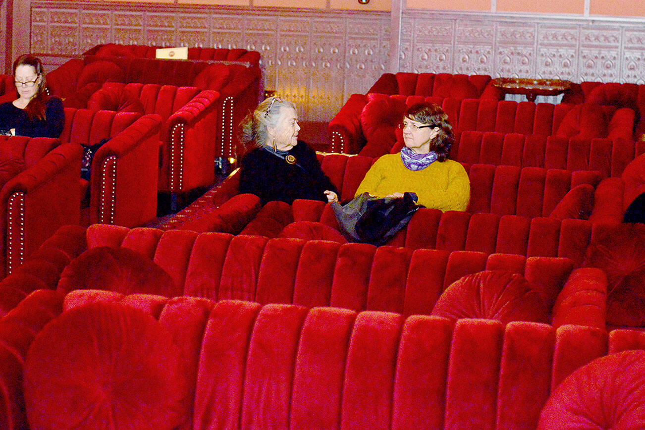 Katherine Baril, center, and other patrons arrived early for a screening of the movie “Ferrari” in the newly made-over Rosebud cinema, part of the Rose Theatre in Port Townsend. (Diane Urbani de la Paz/for Peninsula Daily News)