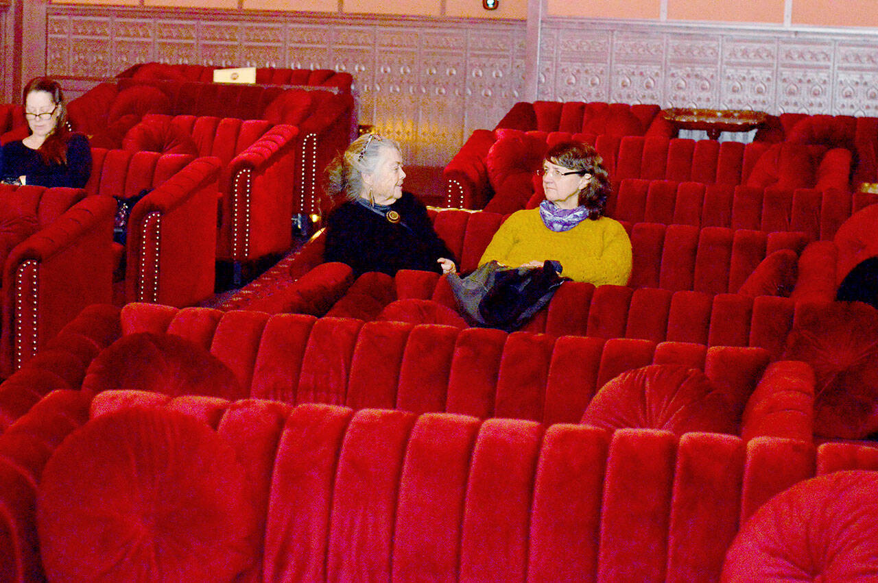 Katherine Baril, center, and other patrons arrived early for a screening of the movie “Ferrari” in the newly made-over Rosebud cinema, part of the Rose Theatre in Port Townsend. (Diane Urbani de la Paz/for Peninsula Daily News)