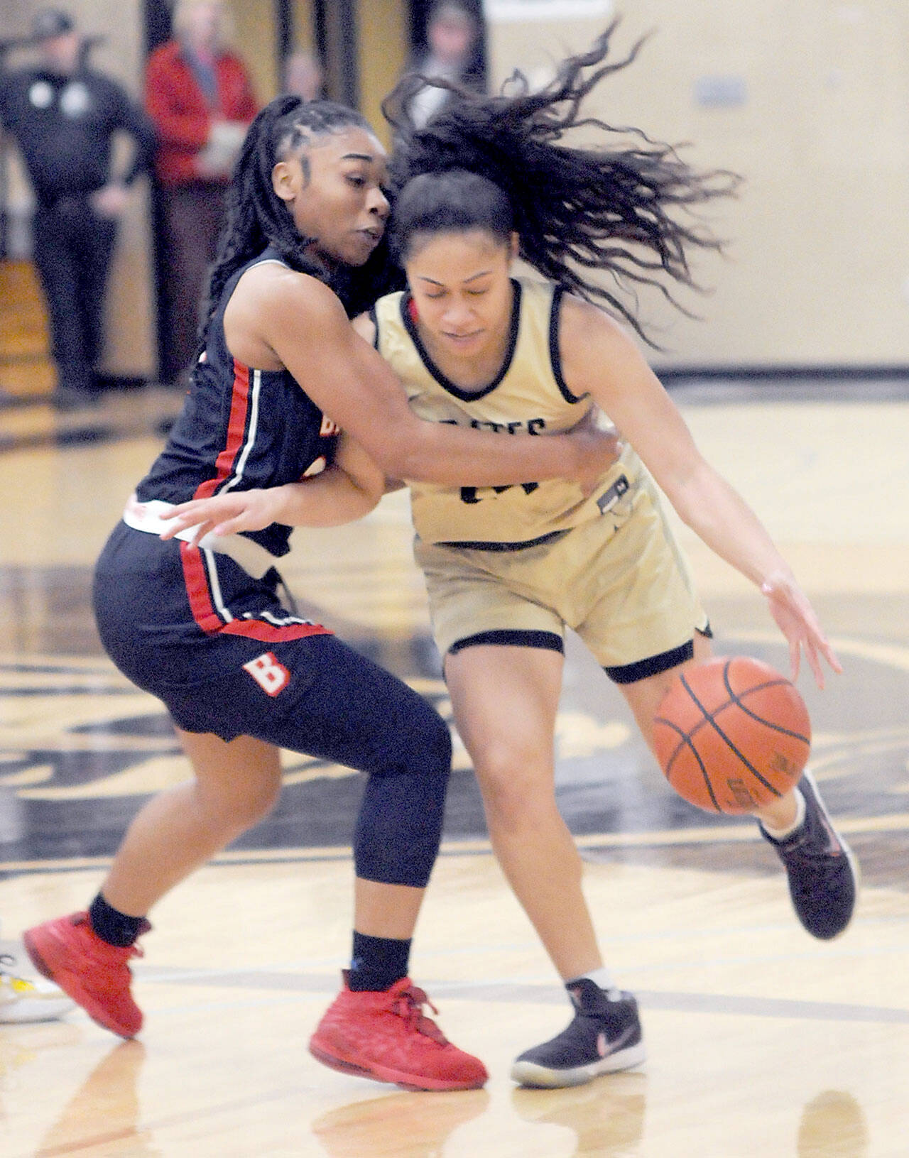 Peninsula’s Shania Moananu, right, is held by Bellevue’s Alicia Morrison on Wednesday night at Peninsula College. (Keith Thorpe/Peninsula Daily News)