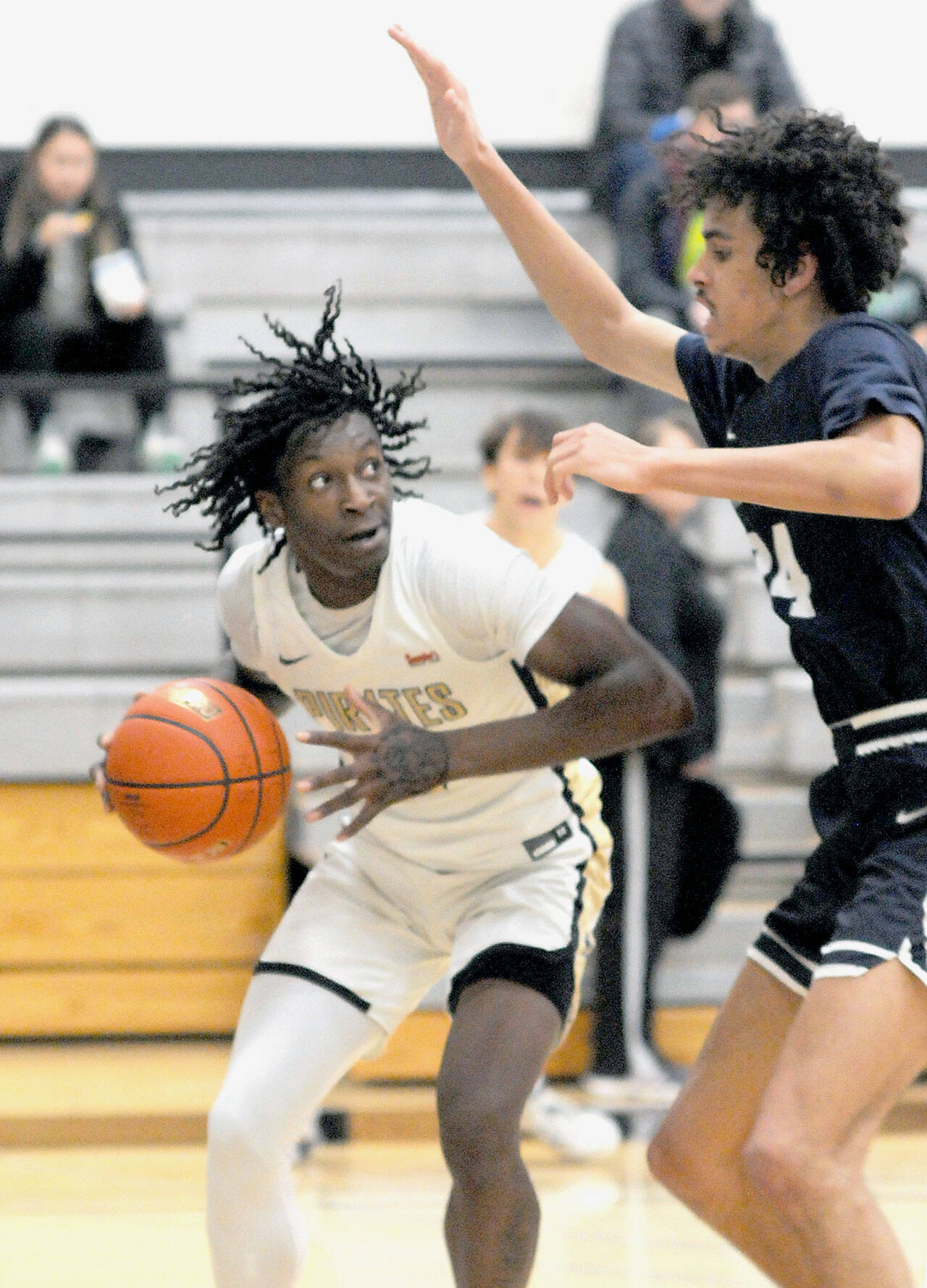 Peninsula’s Ese Onakpoma, left, eyes his opponent, Bellevue’s Mehki Alexander, during Wednesday’s game at Peninsula College. (Keith Thorpe/Peninsula Daily News)