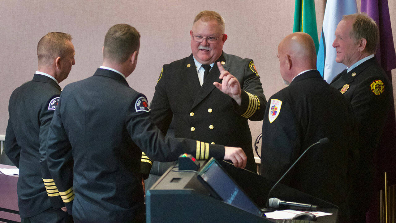 Deputy chief Justin Grider with Clallam County Fire District 2, center, has accepted an offer to become Fire District 3’s next fire chief. Here he stands with, from left, Port Angeles Fire Department Chief Derrell Sharp, Joel McKeen, Port Angeles Fire Department assistant chief, Joyce Fire and Rescue chief Greg Waters and Fire District 3 interim fire chief Dan Orr. (Jay Cline)