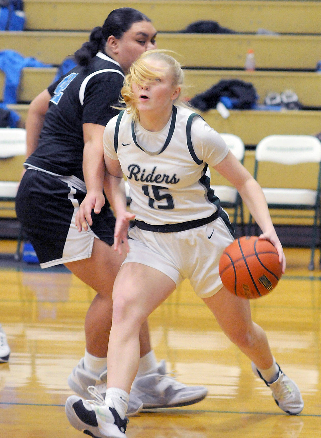 KEITH THORPE/PENINSULA DAILY NEWS Port Angeles’ Paige Mason, front, steps into the lane past the defense of North Mason’s Tanza Tupolo on Thursday at Port Angeles High School.